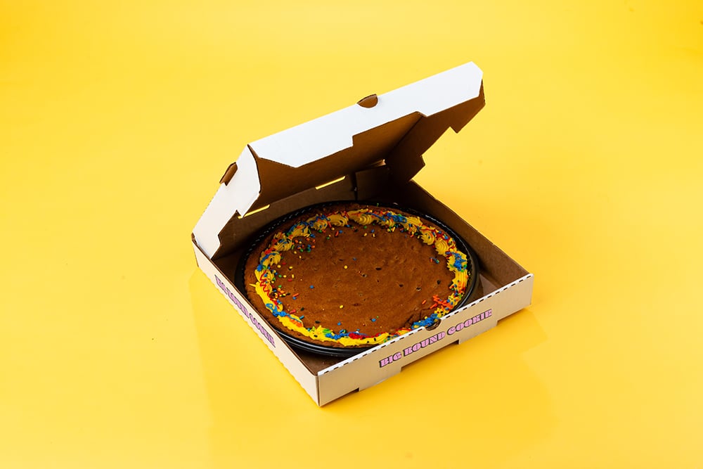 A cookie cake in a pizza box.