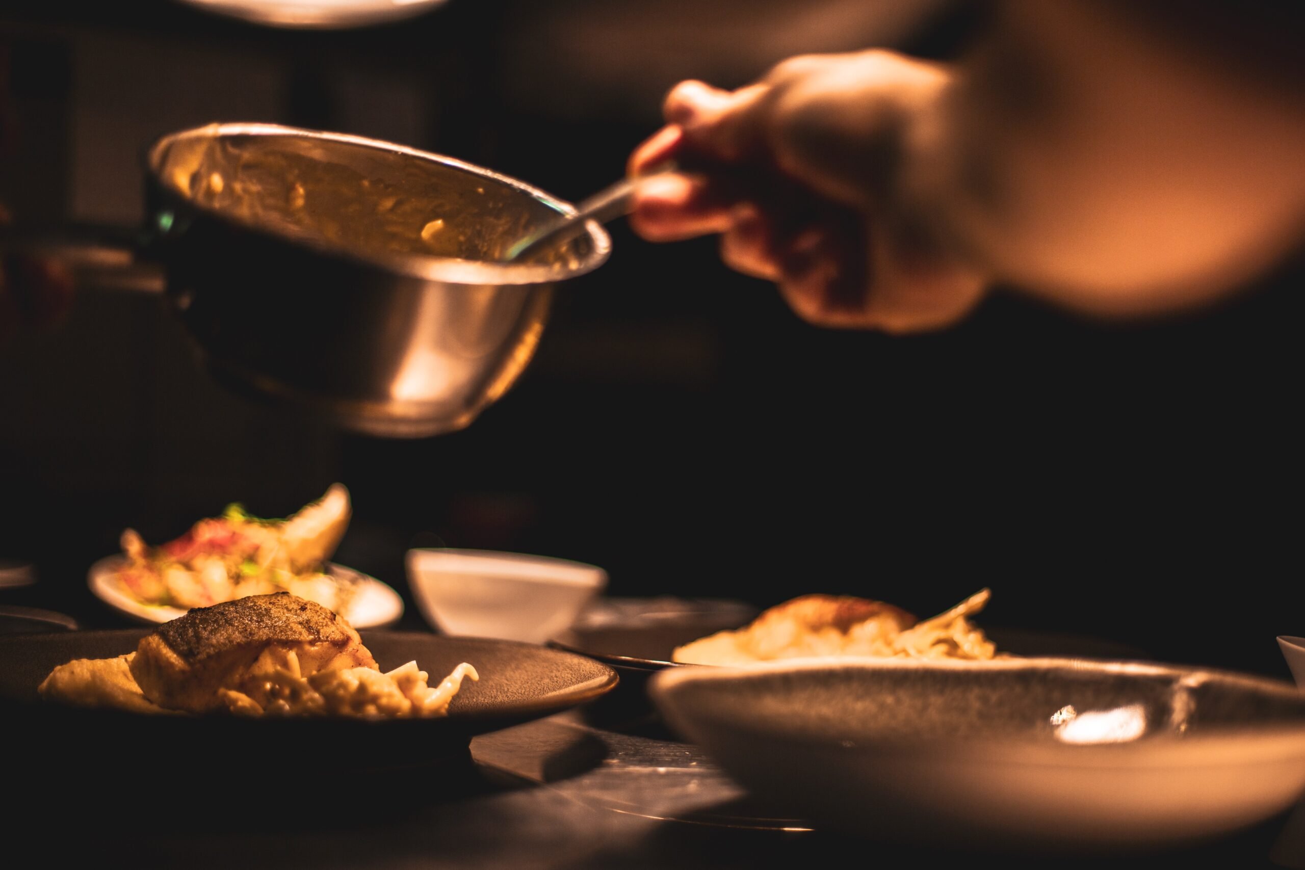 Hand serving from bowl to dinner plate