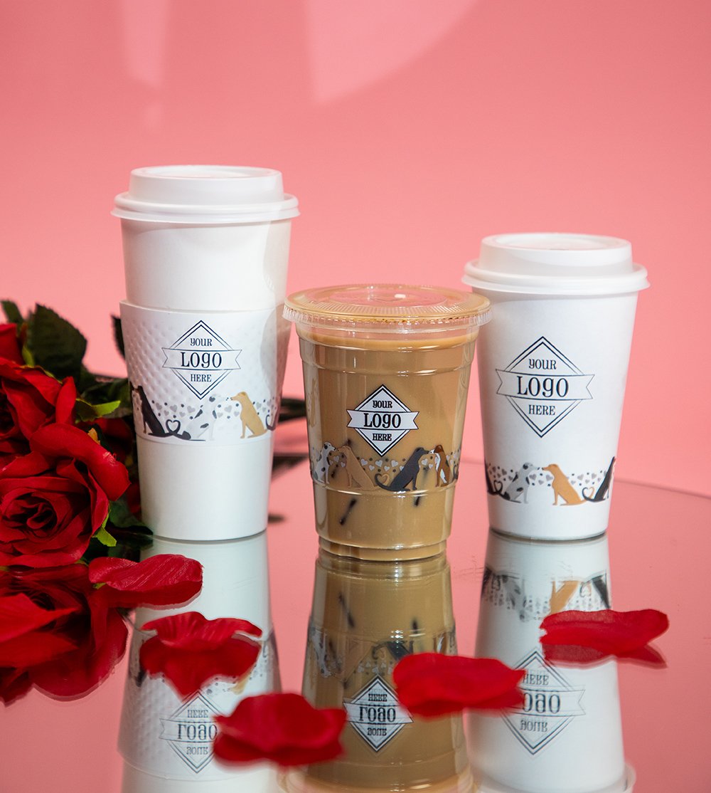 Valentine's Day themed cups on a mirror with rose petals and pink backdrop.