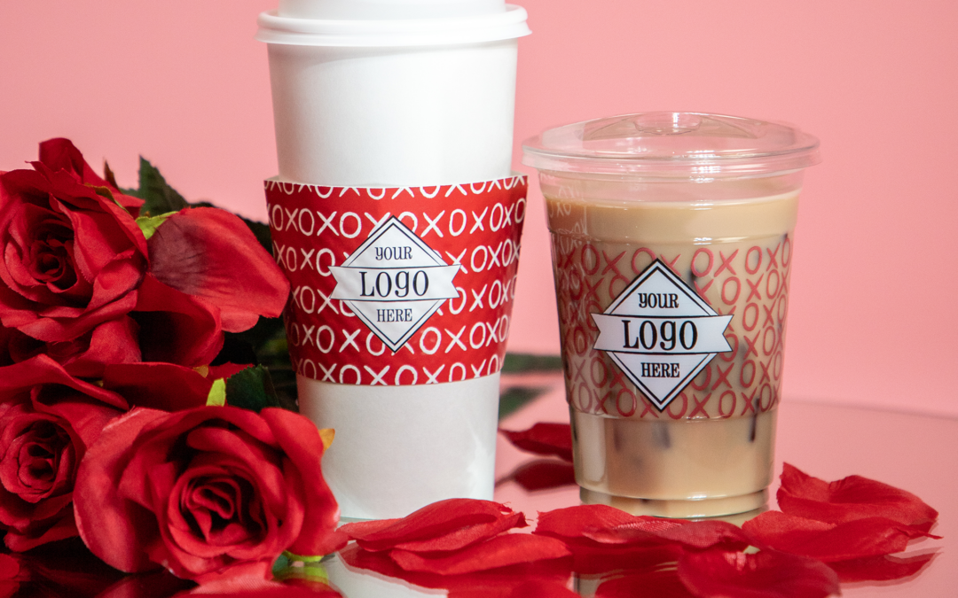 Valentine's Day themed cups on a mirror with rose petals and pink backdrop.