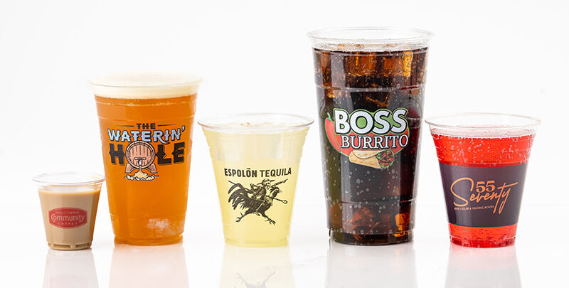 A variety of plastic cups displaying custom logos and colored beverages.