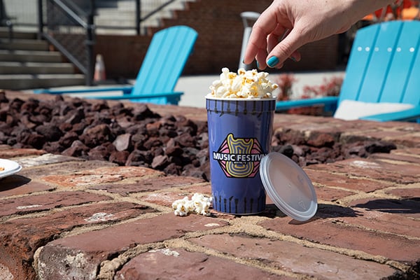 Stadium cup full of popcorn.