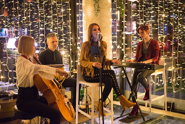 Musical band playing music on the small concert stage at night i