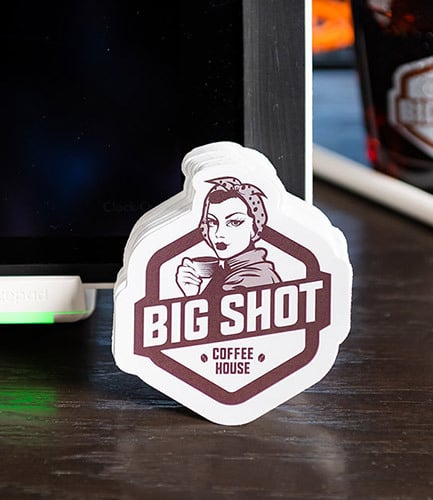 stickers-master-image Custom printed, custom shape stickers leaning against a point of sale system.