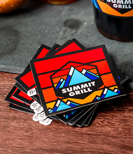 A stack of custom shaped logo stickers